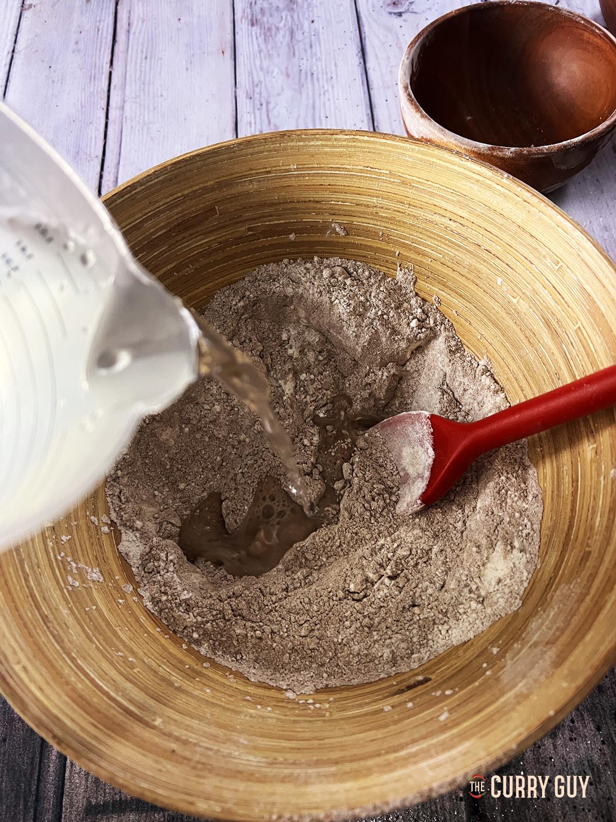 Adding water to make the batter.