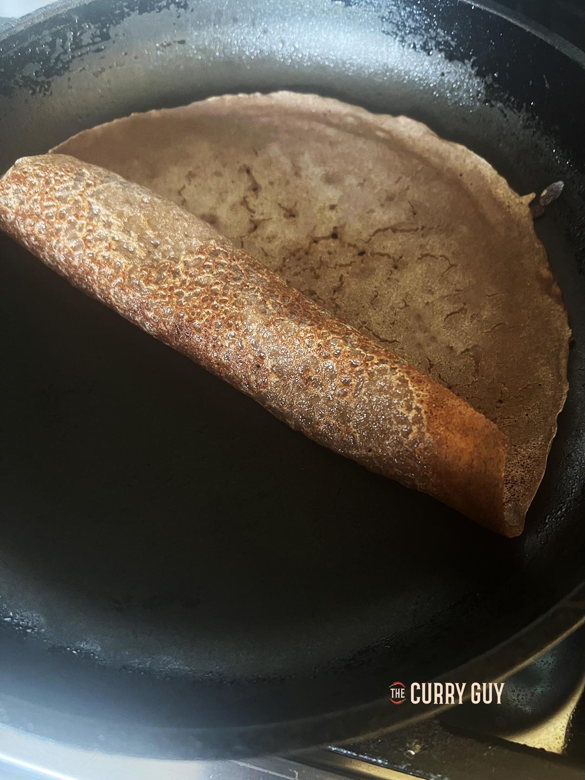 Rolling an injere bread in the pan.