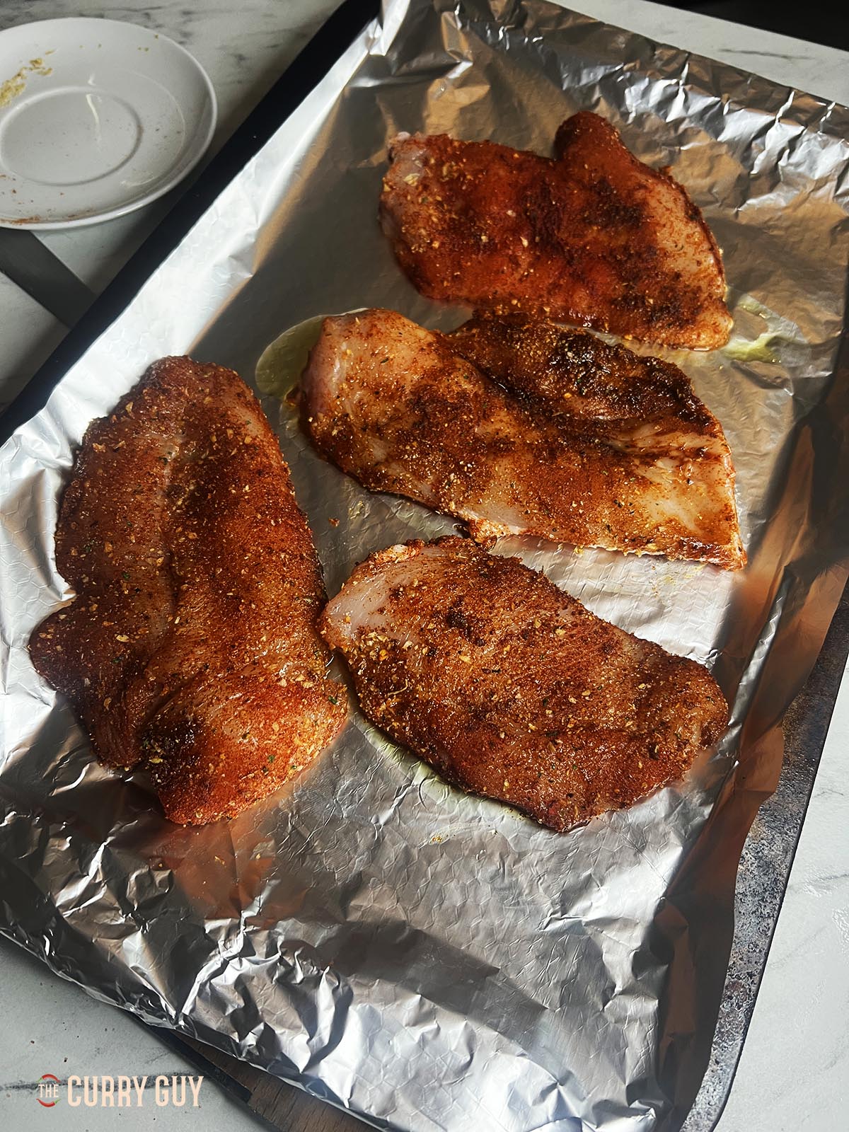 Chicken with marinade ready to go in the oven.