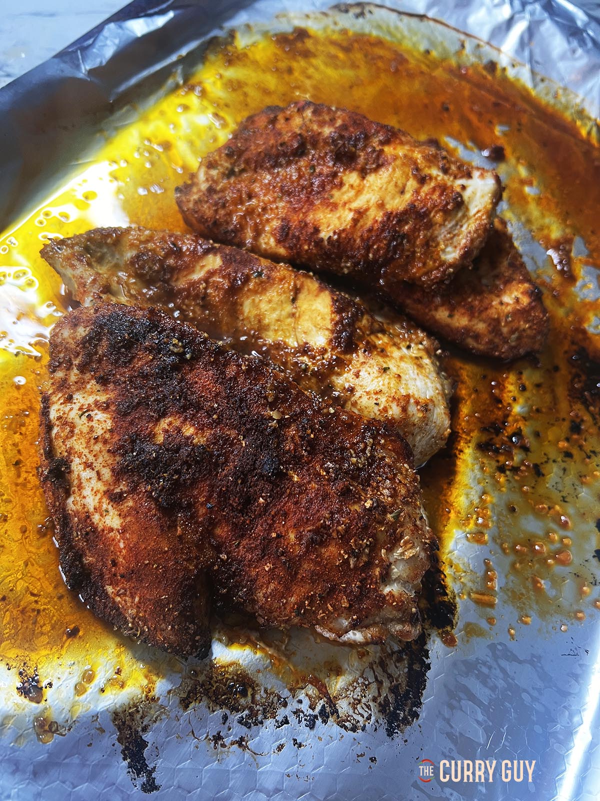 Cooked peri peri spiced chicken breasts.