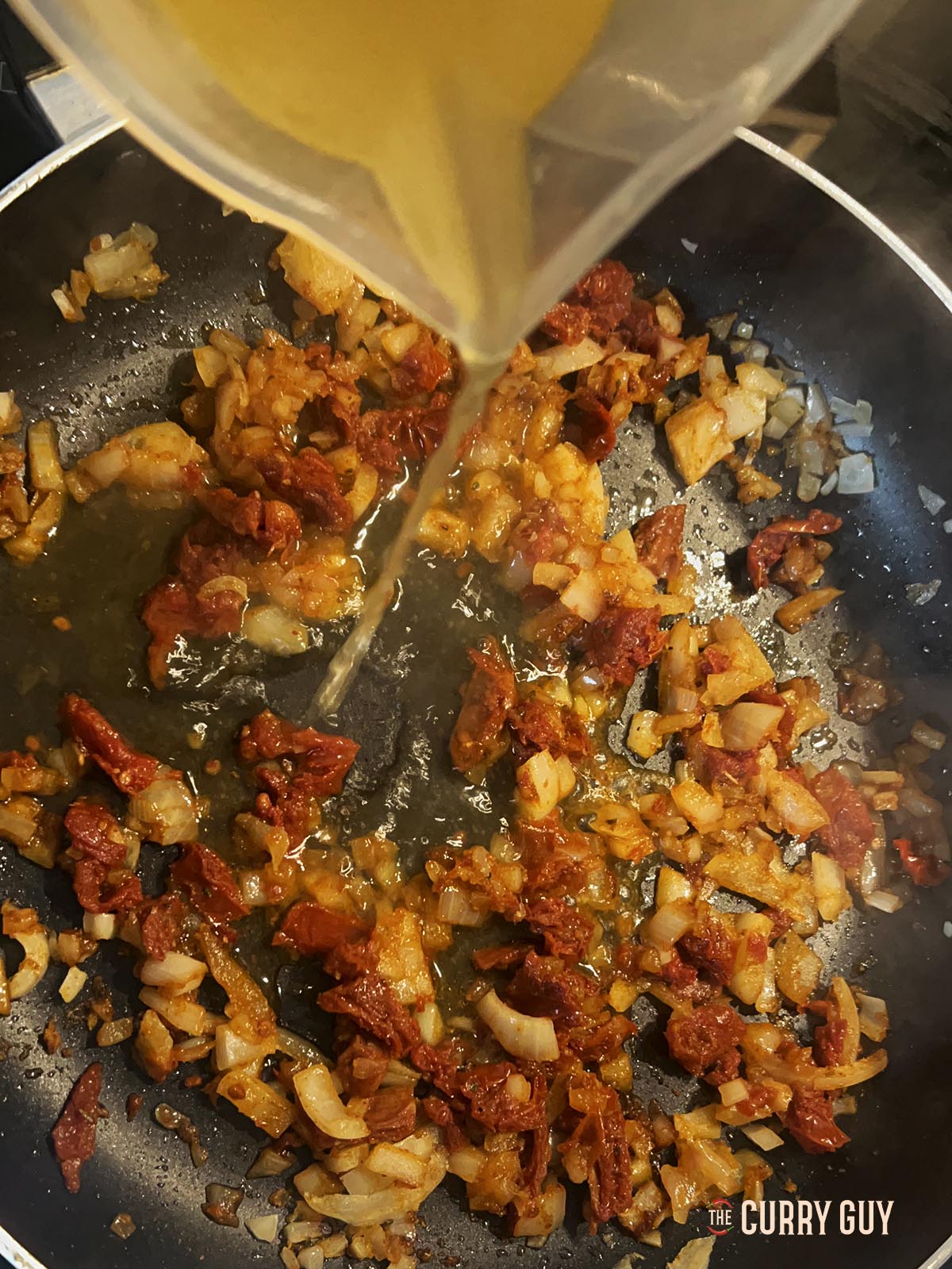 Adding stock to the pan