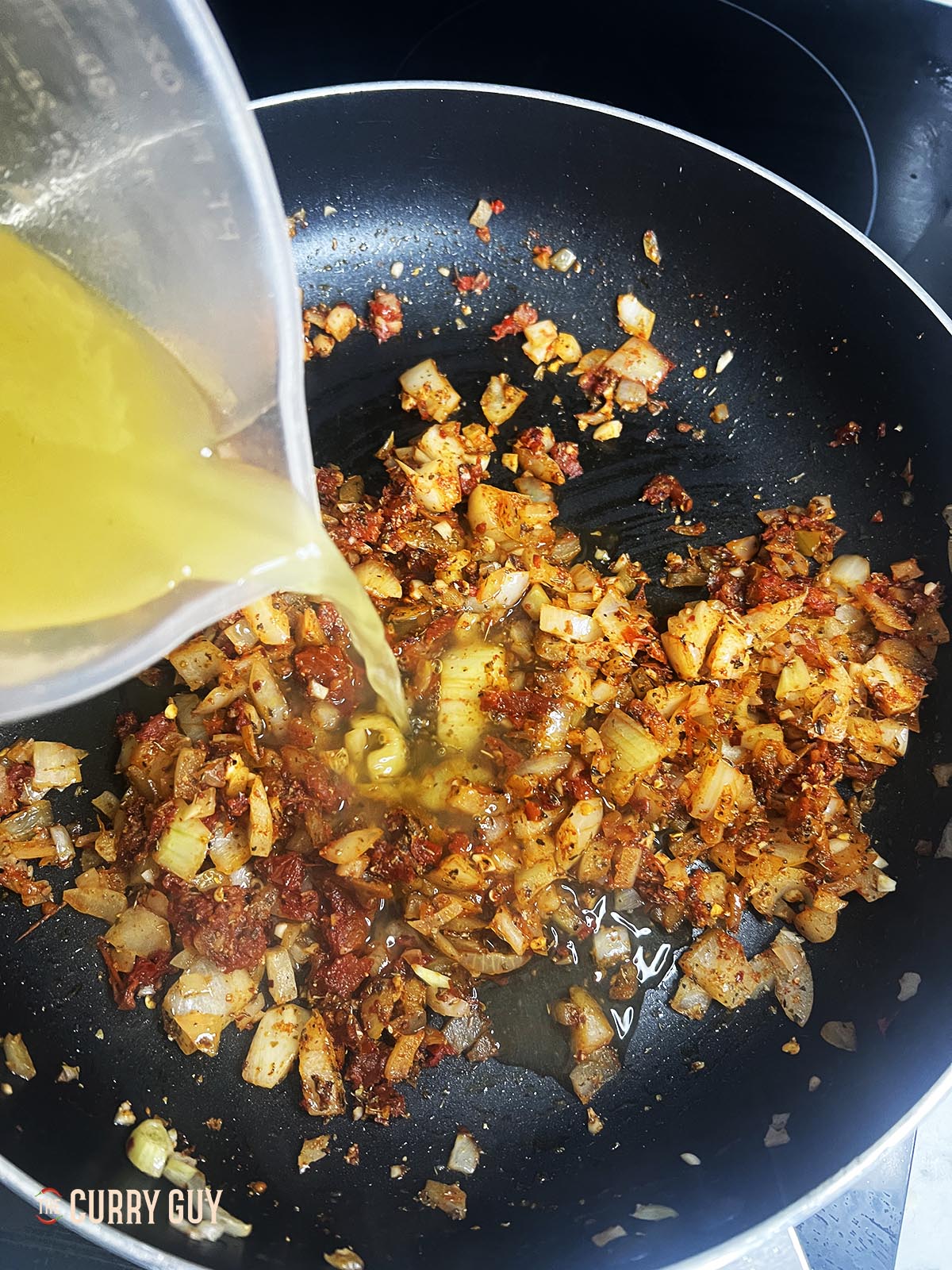 stock pouring in pan for the Marry Me Chicken Pasta