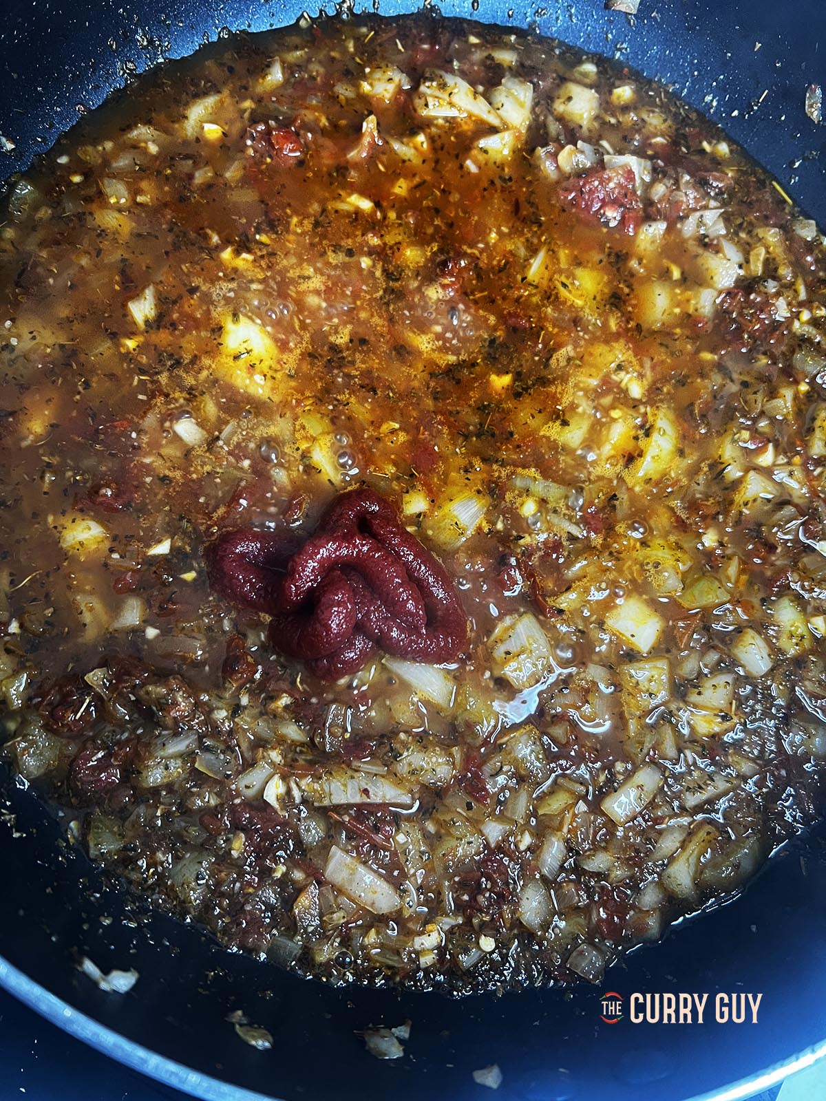 tomato puree added to pan 