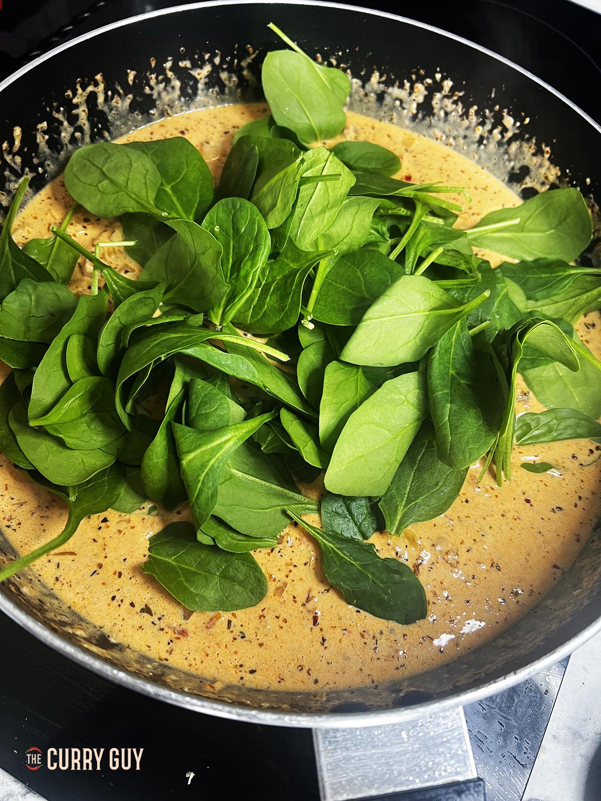 adding spinach to the Marry Me Chicken Pasta