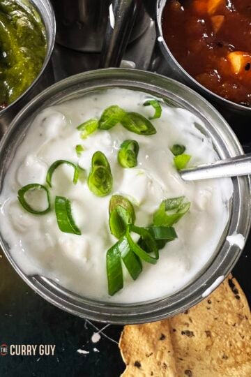Onion raita in a serving bowl.