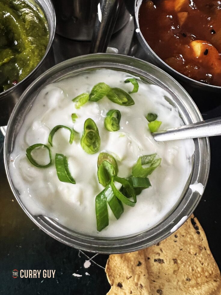 Onion raita in a serving bowl.