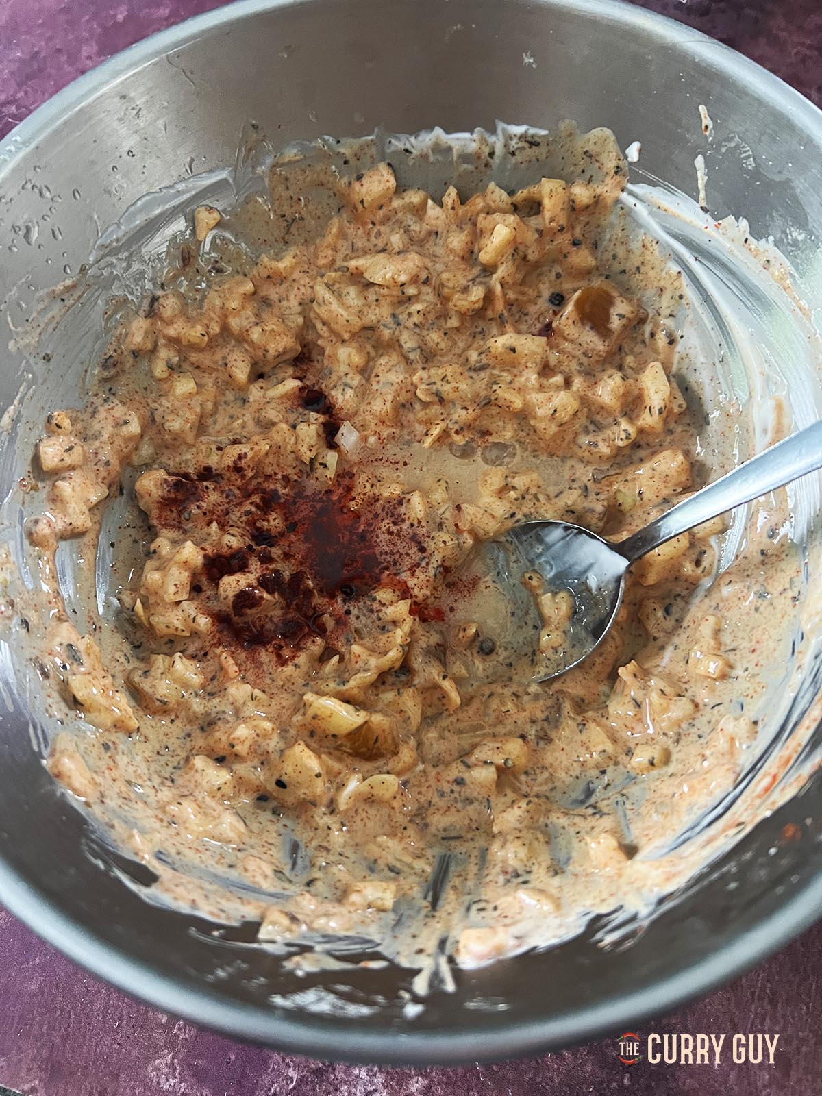 Adding food colouring to the pakora sauce.