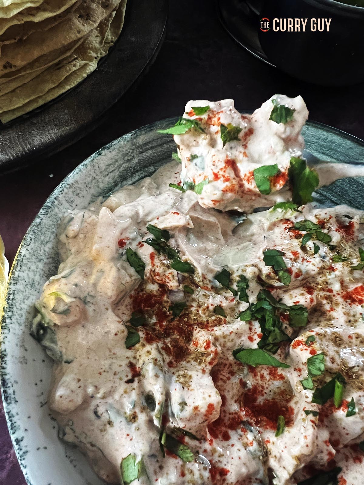 Potato raita on a spoon.