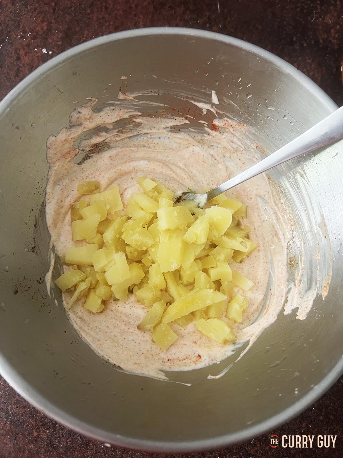 Adding the boiled and cooled diced potato.