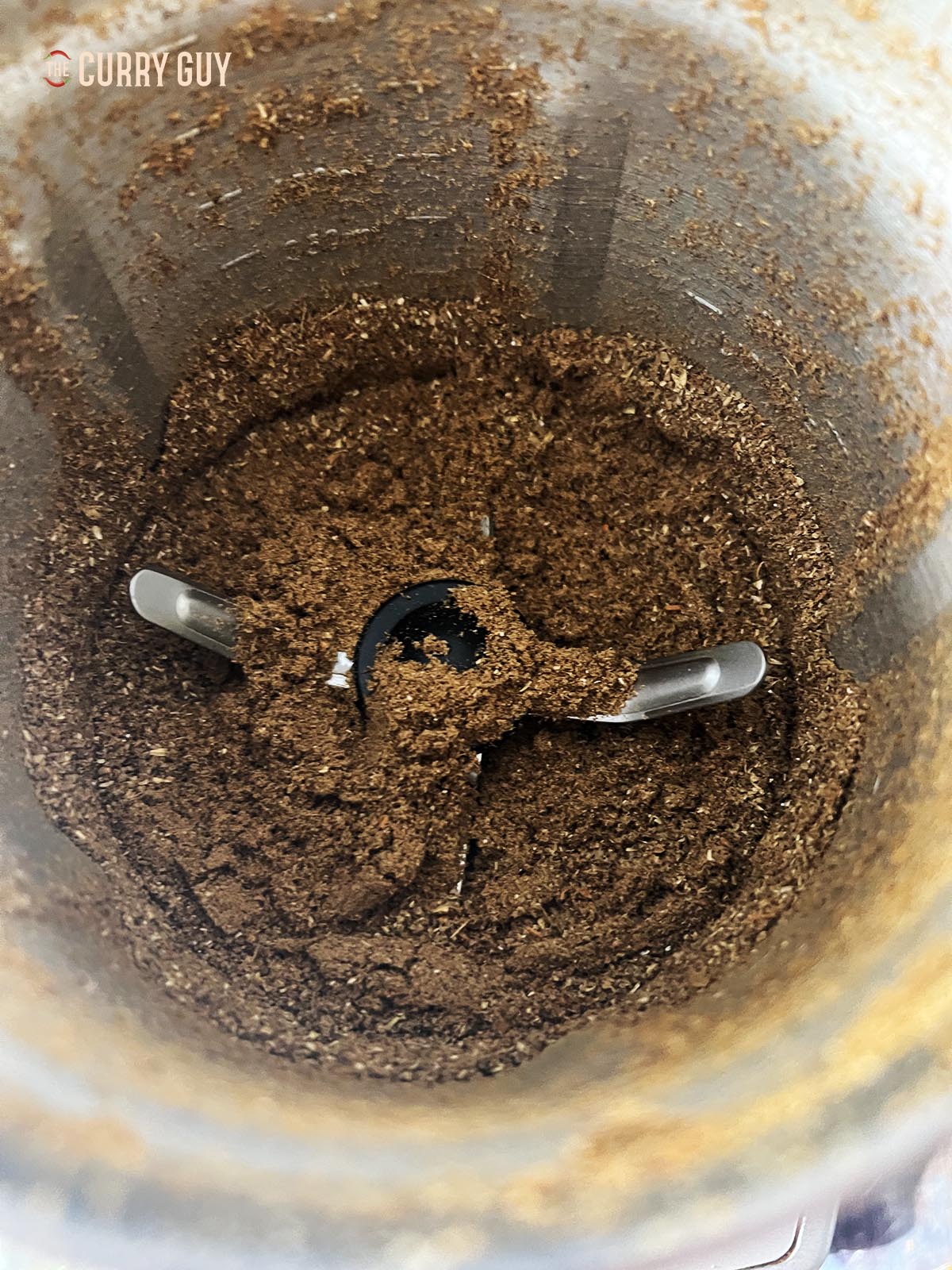 Grinding the spices into a powder.