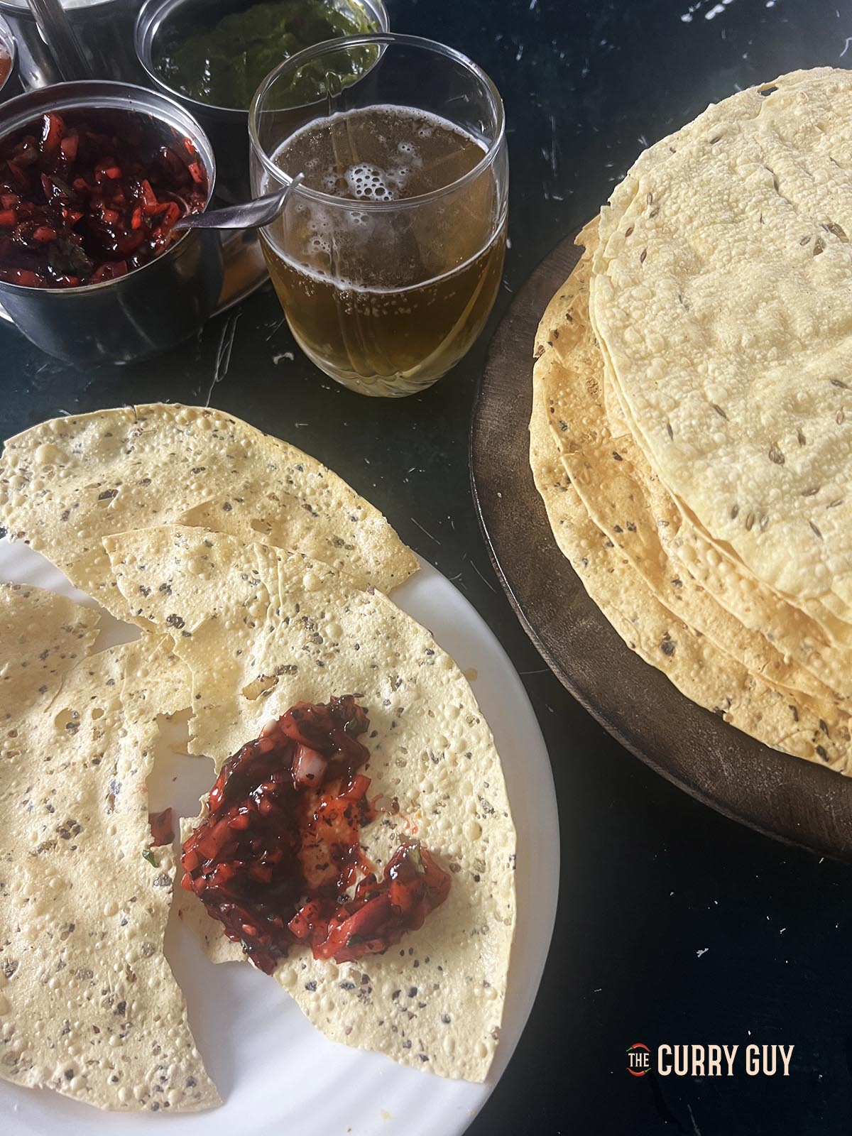 Red onion chutney on a poppadom.