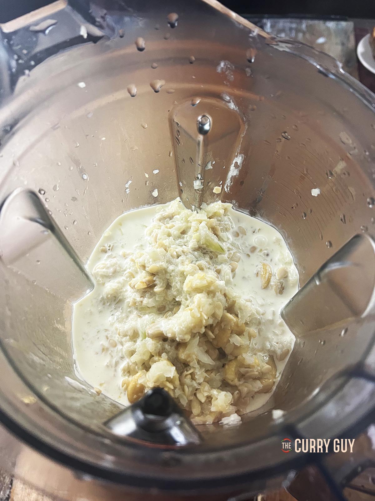 Placing the onion mixture, cream and yoghurt in a blender.
