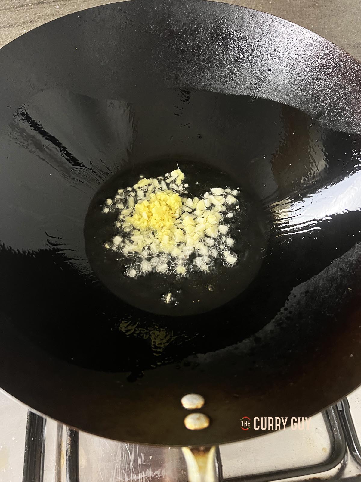 Frying the garlic and ginger in a little oil in a wok. 