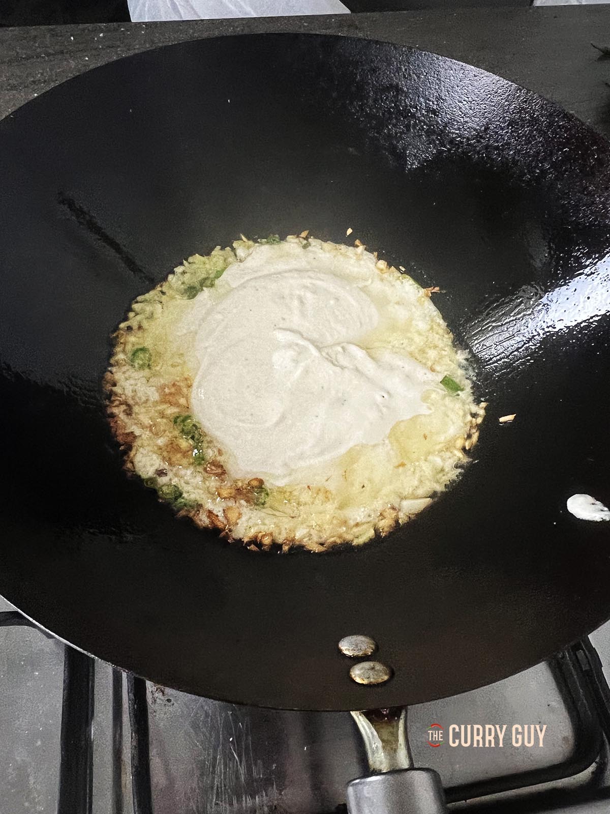 Adding the white gravy to the pan.