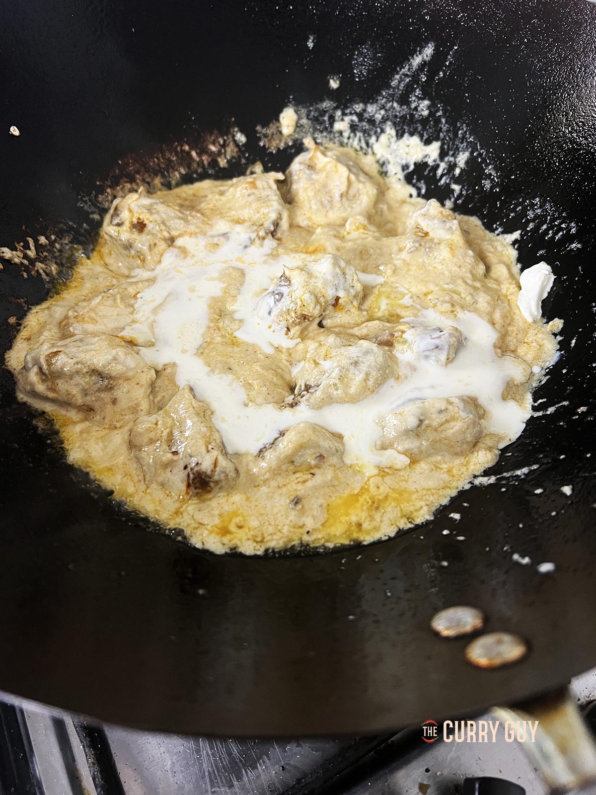 Stirring the cream into the sauce.