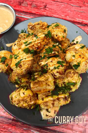 Air fryer bang bang chicken garnished and ready to eat on a plate.