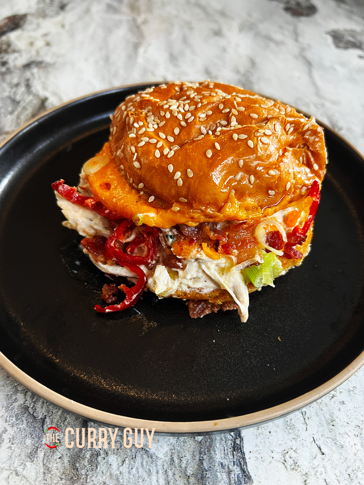Chicken served in a bun with chilli and scallions