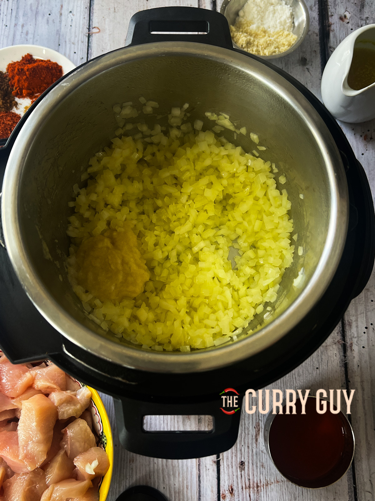 Onions and garlic added to slow cooker chicken tikka masala