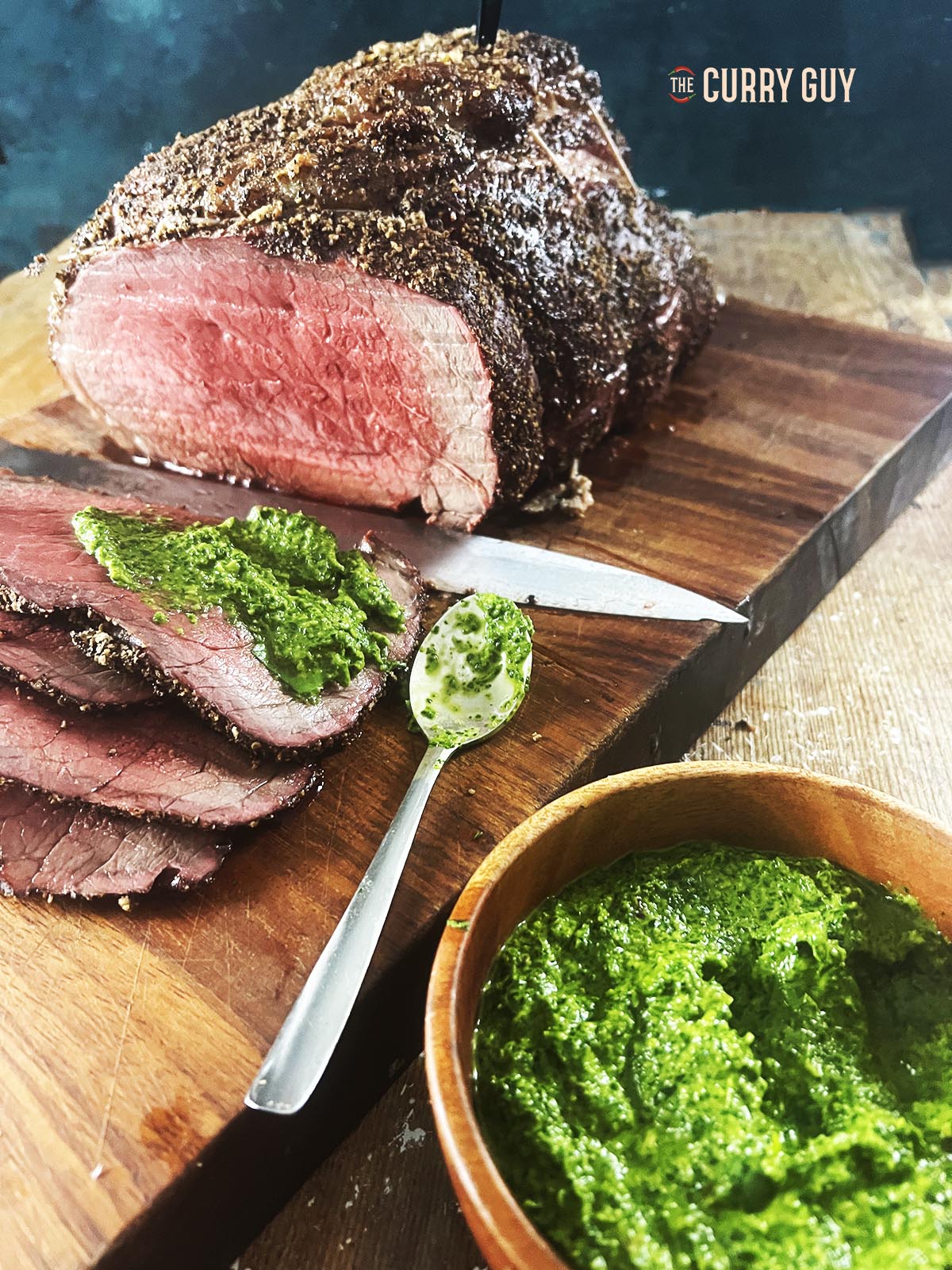 Asian chimichurri sauce next to and on roast beef.