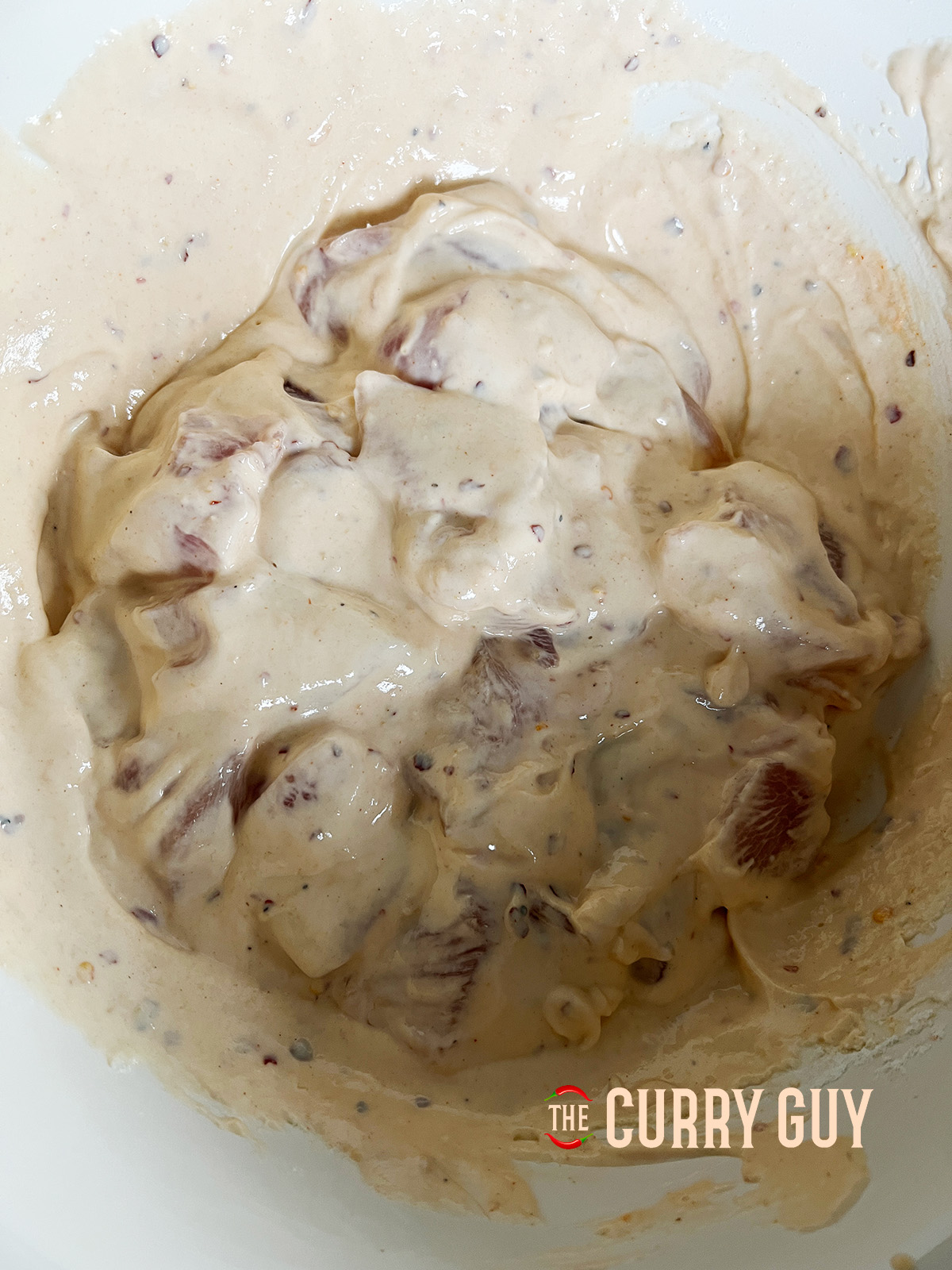 Chicken mixed in to Air Fryer Bang Bang Chicken batter in a bowl