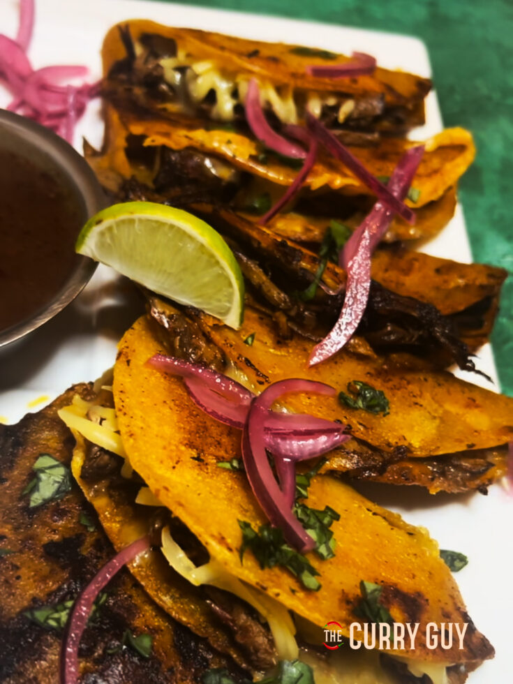 crock pot birria tacos on a plate