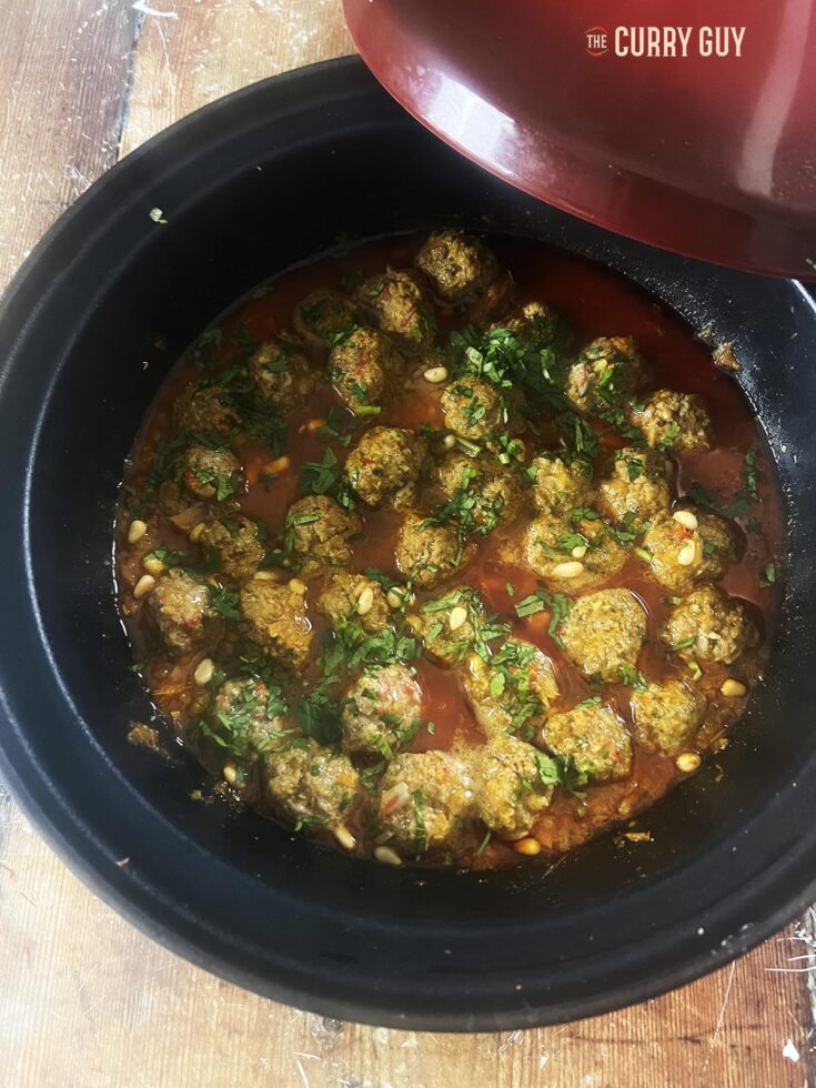 moroccan meatballs in saffron butter sauce served in a tagine.