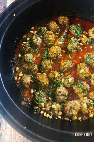 Moroccan meatballs in saffron butter sauce, served in a tagine.