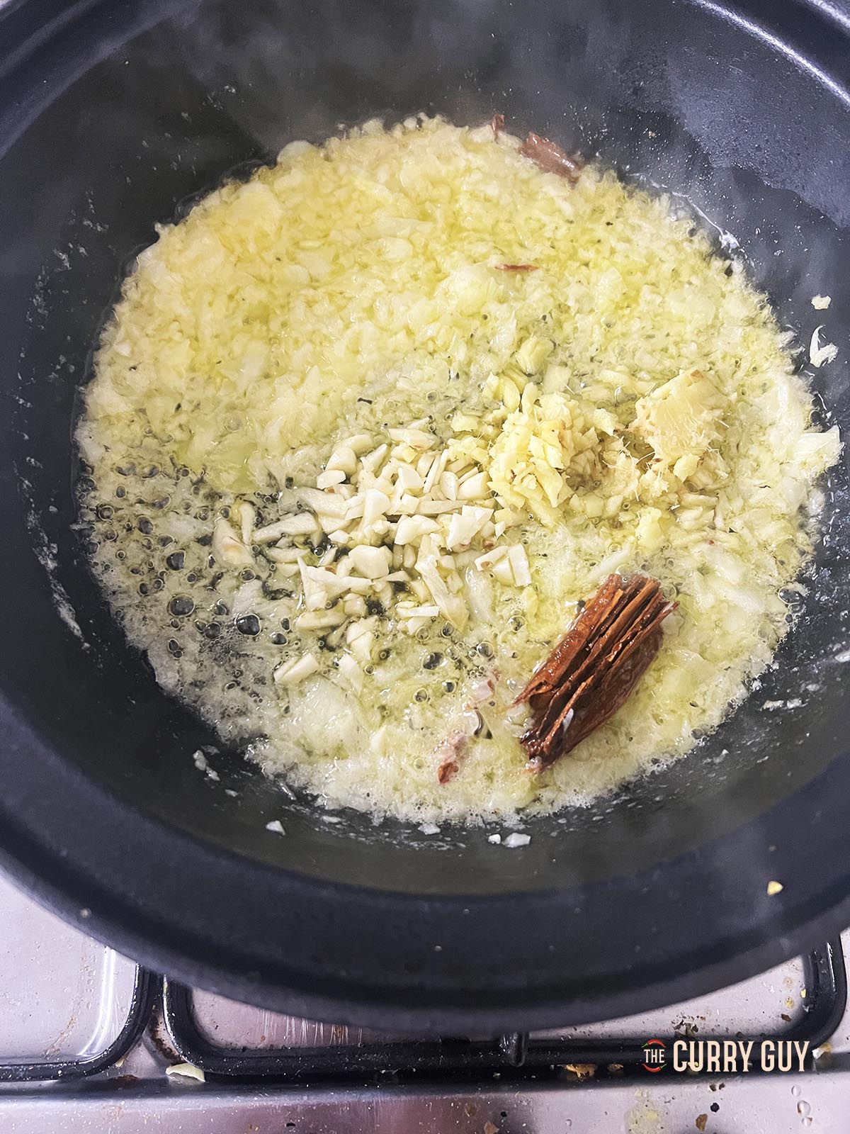 Adding the onion and chopped garlic and ginger.