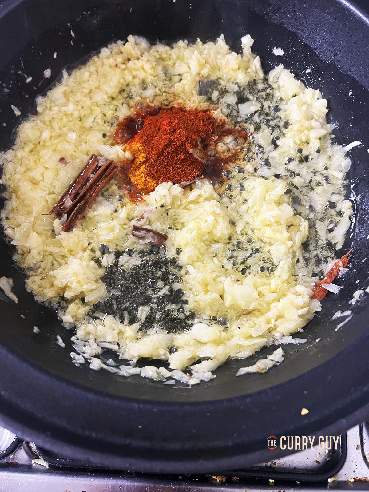 Adding the ground spices to the onion, butter mixture.