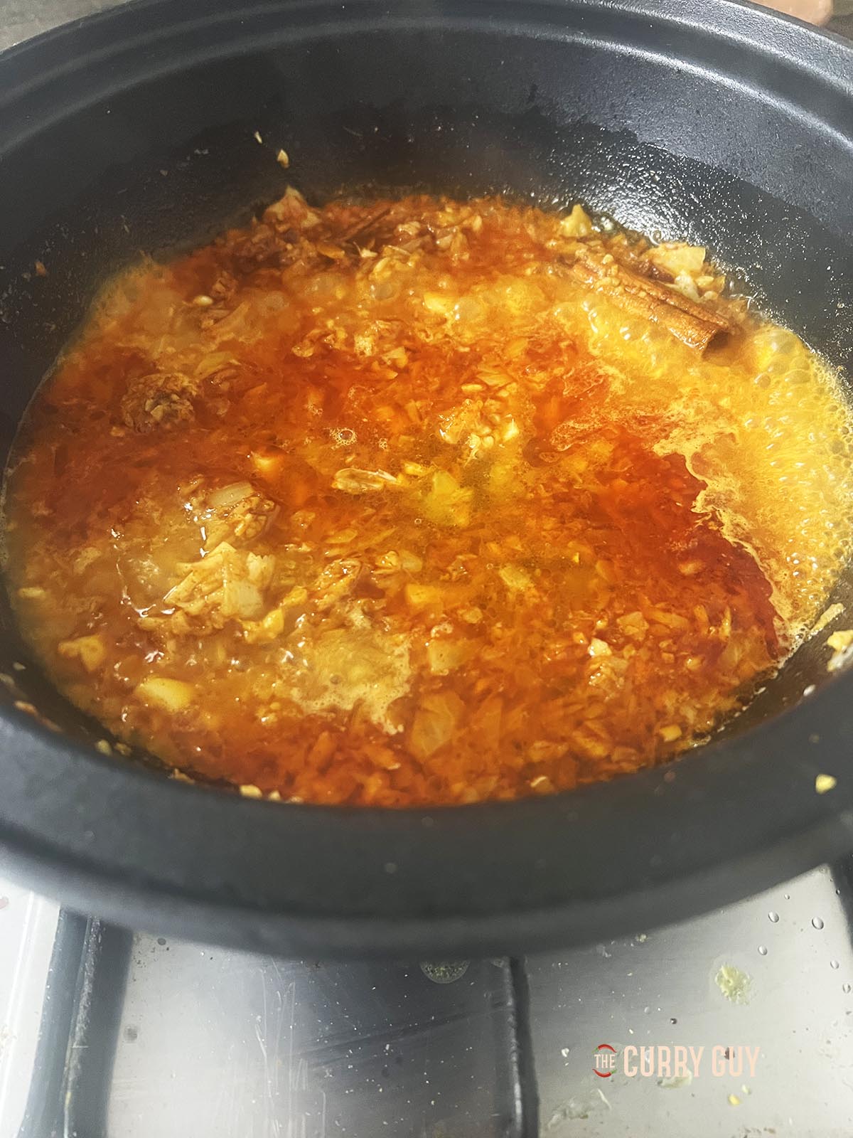 Adding the water or stock to the pan and bring to a simmer.