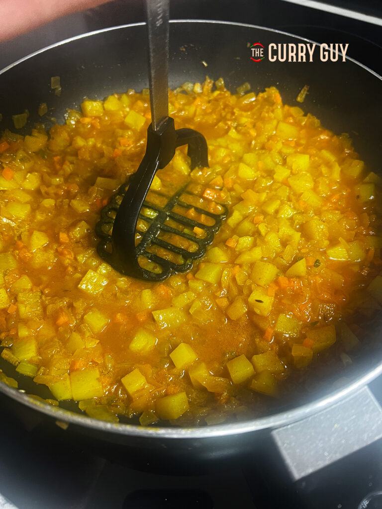 mashing the potatoes