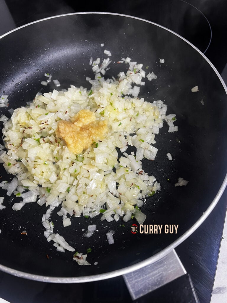 Garlic and ginger paste with onions in a pan. 