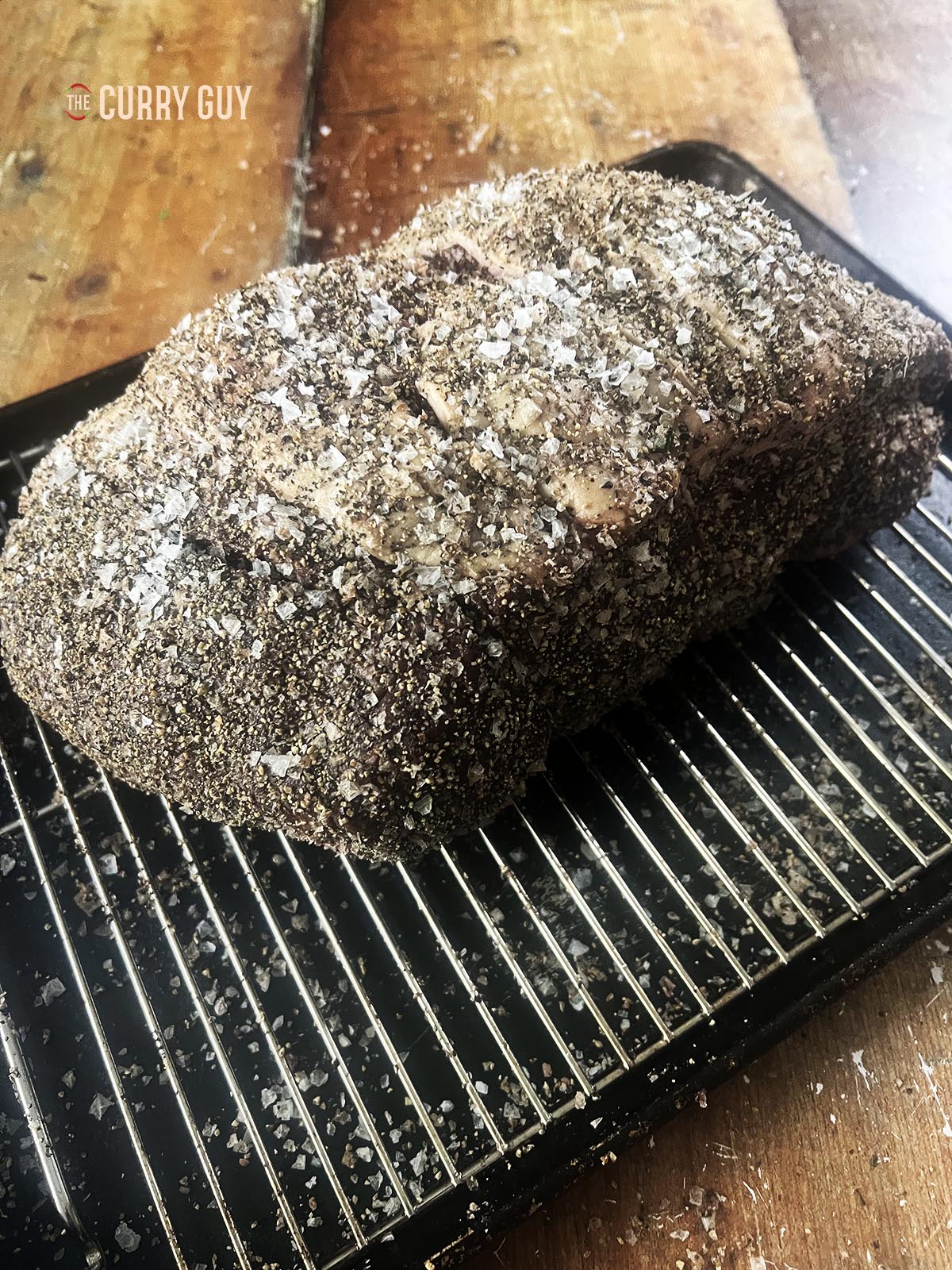 The top round covered in salt and pepper.