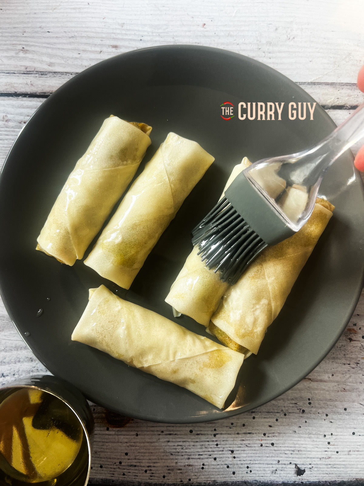 Brushing spring roll with oil for crispiness