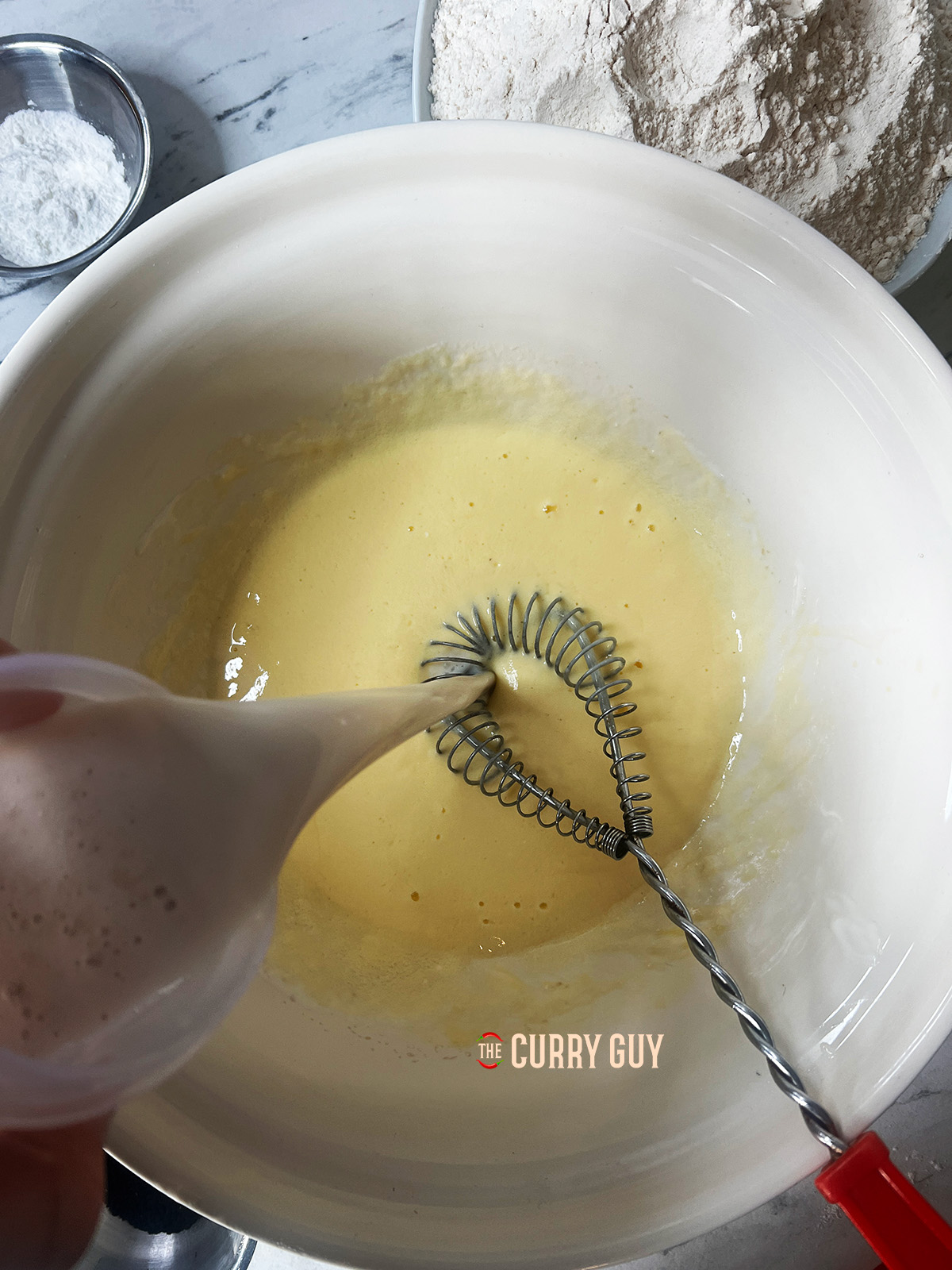 mixing liquid ingredients together in the bowl. 