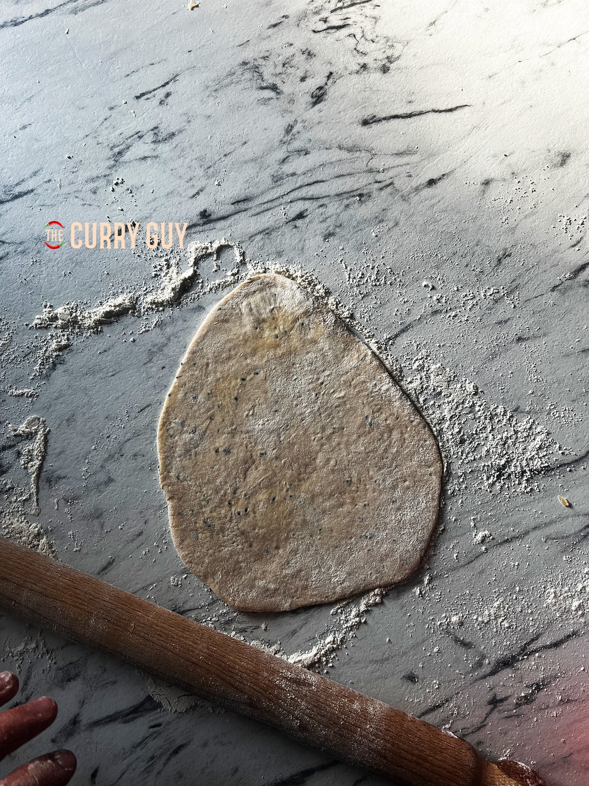 Rolling out naan bread.