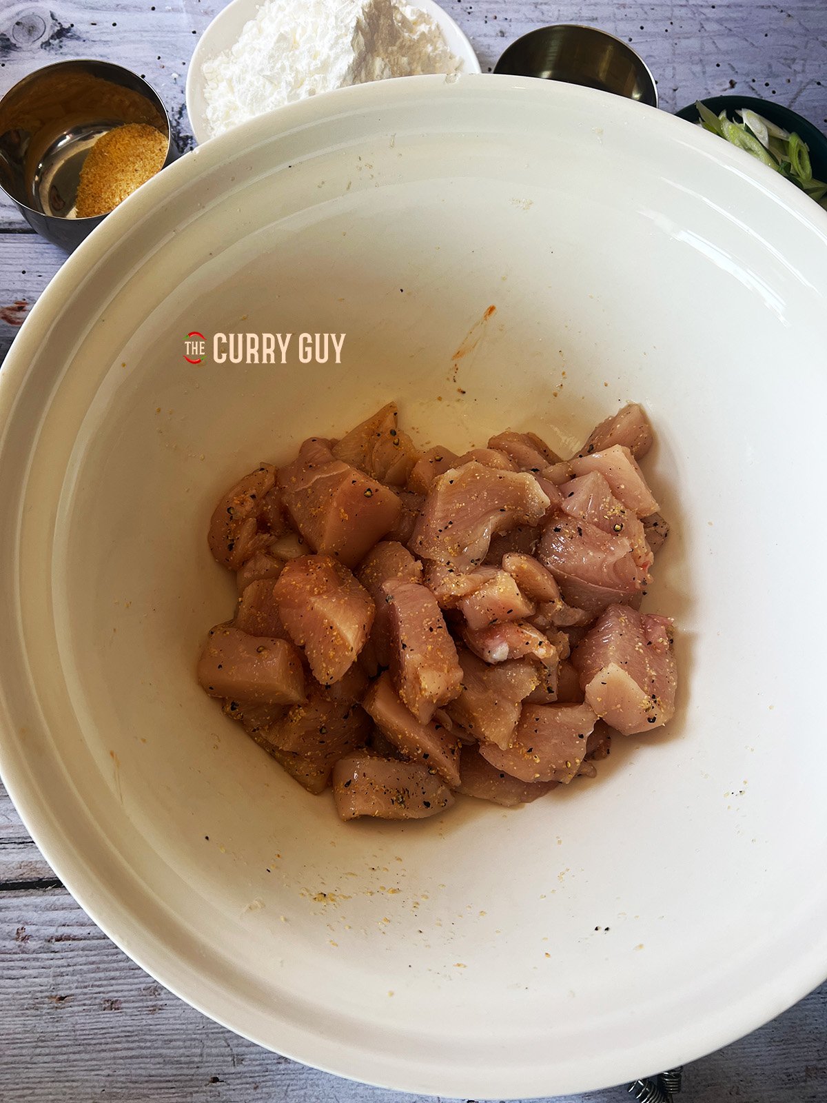 marinating chicken in a bowl. 