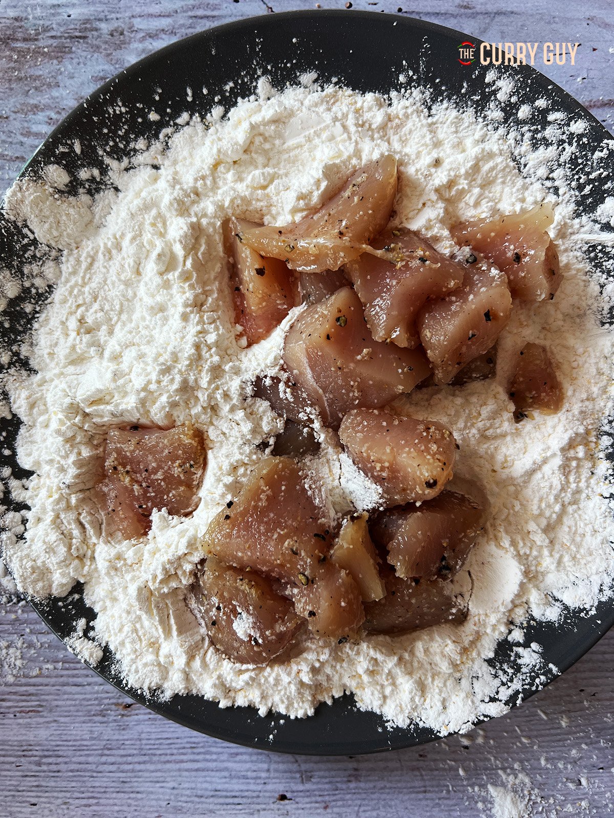 coating the Air Fryer Korean Fried Chicken in the flour mix. 
