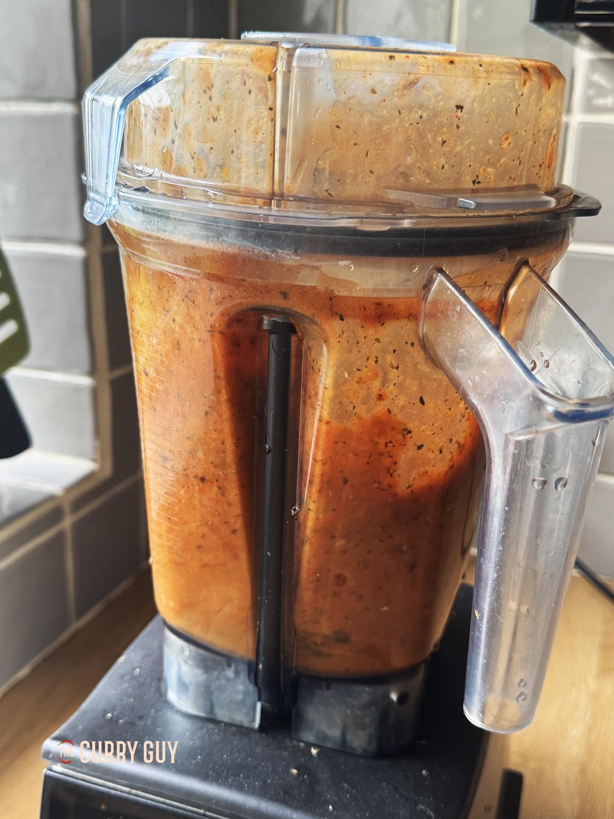Blending the sauce ingredients in a bowl until smooth.