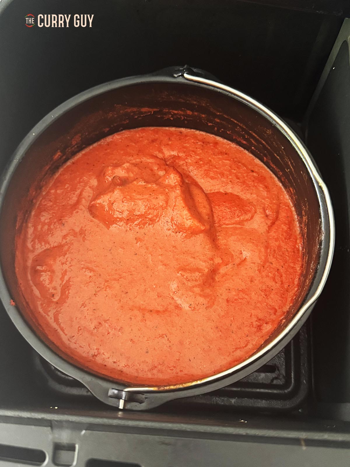 Placing the sauce in the air fryer. 