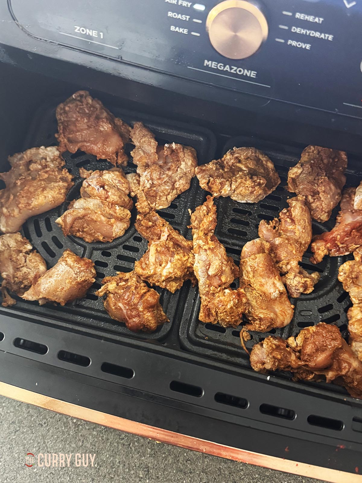Air frying the marinated chicken.