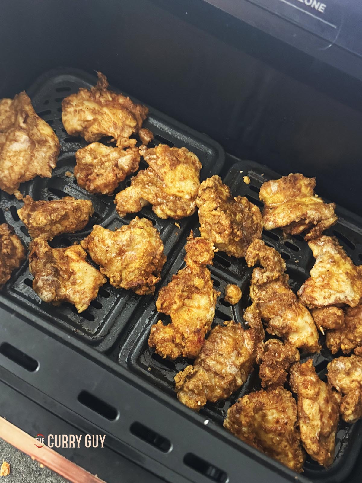 Turning the chicken for a more even cook.