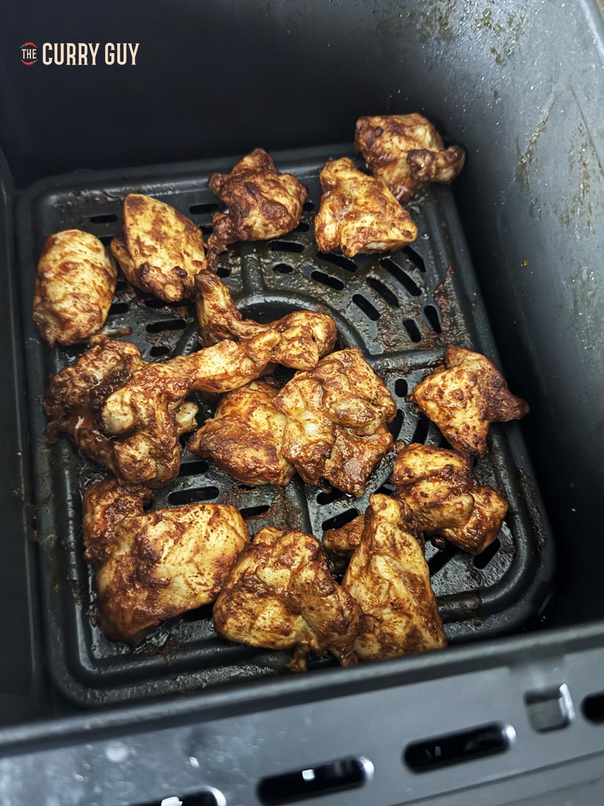 Air frying chicken in the air fryer basket.