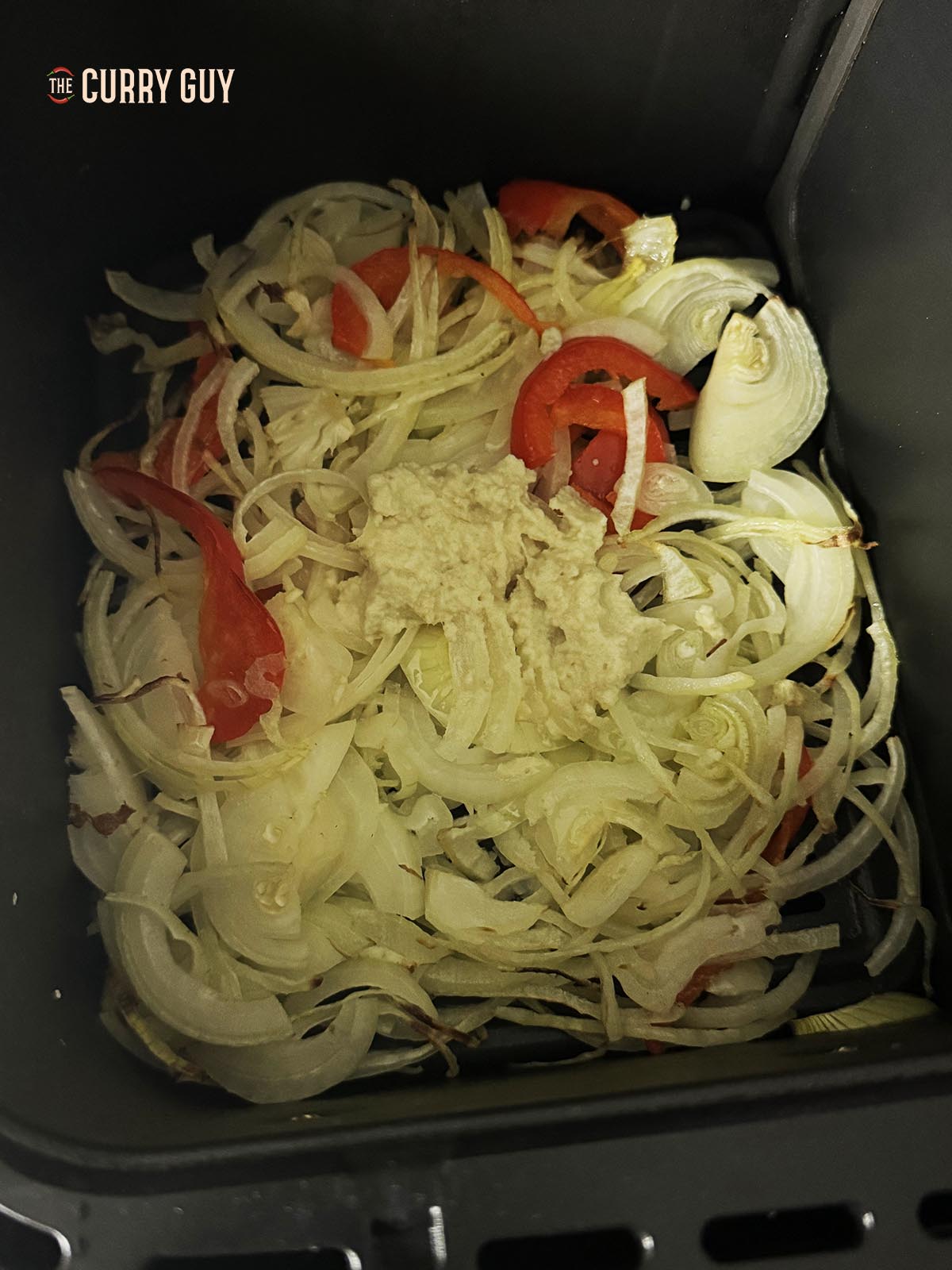 Air frying the sliced onions, bell pepper and garlic and ginger paste.