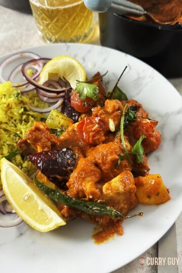 Air fryer chicken jalfrezi served on a plate at the table.