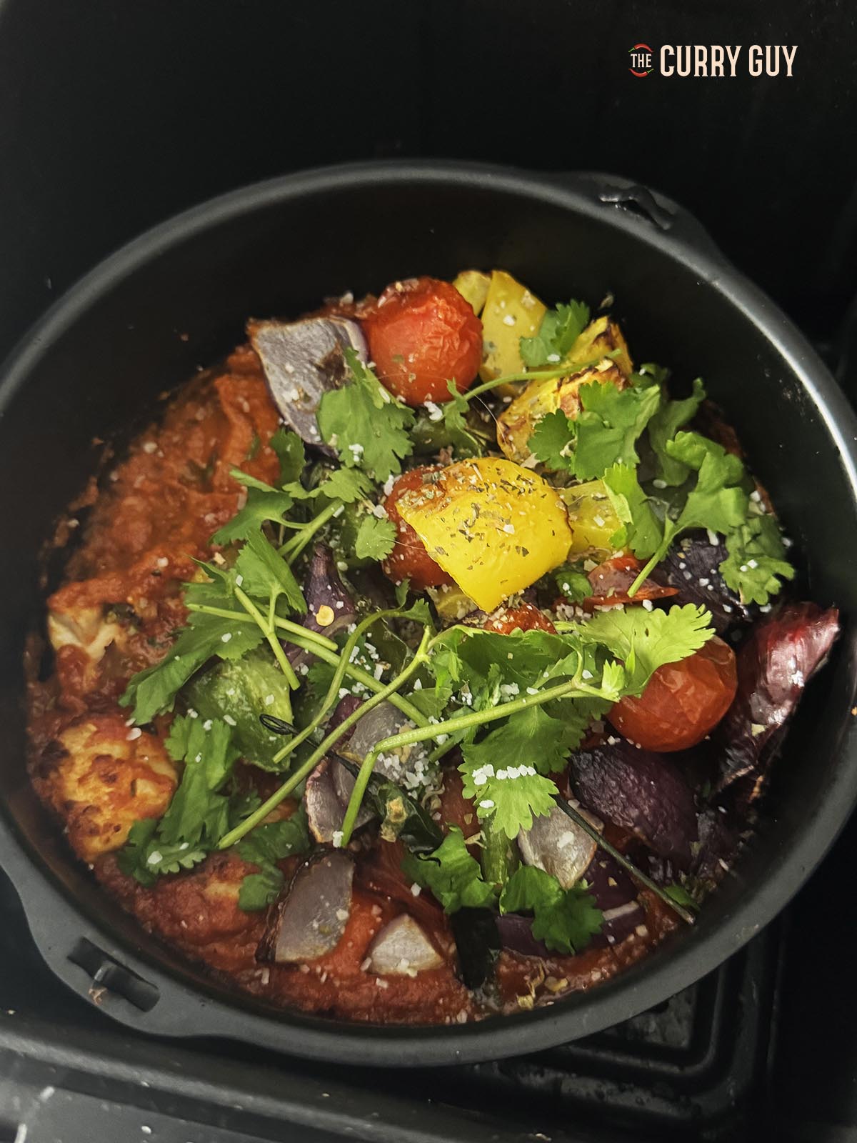 Seasoning the jalfrezi with dried fenugreek leaves, salt, coriander and lemon juice.