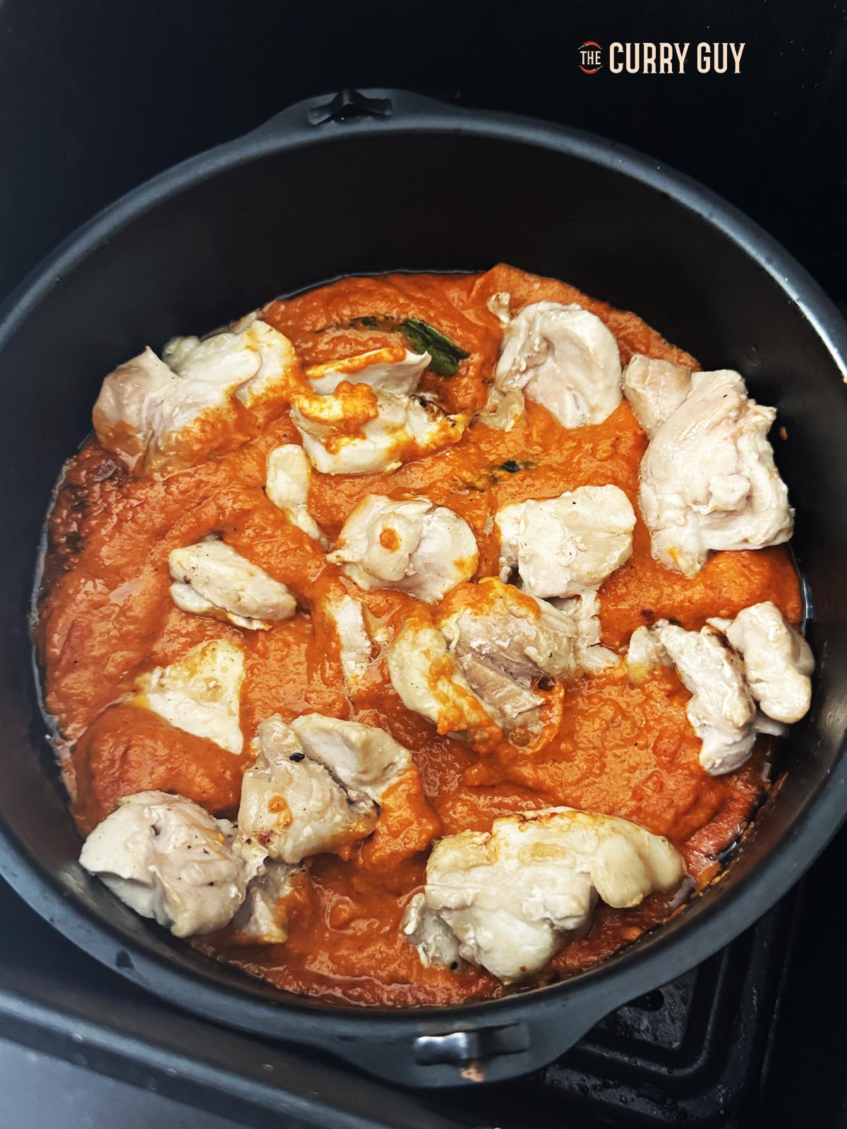 Adding the chicken to the pan.
