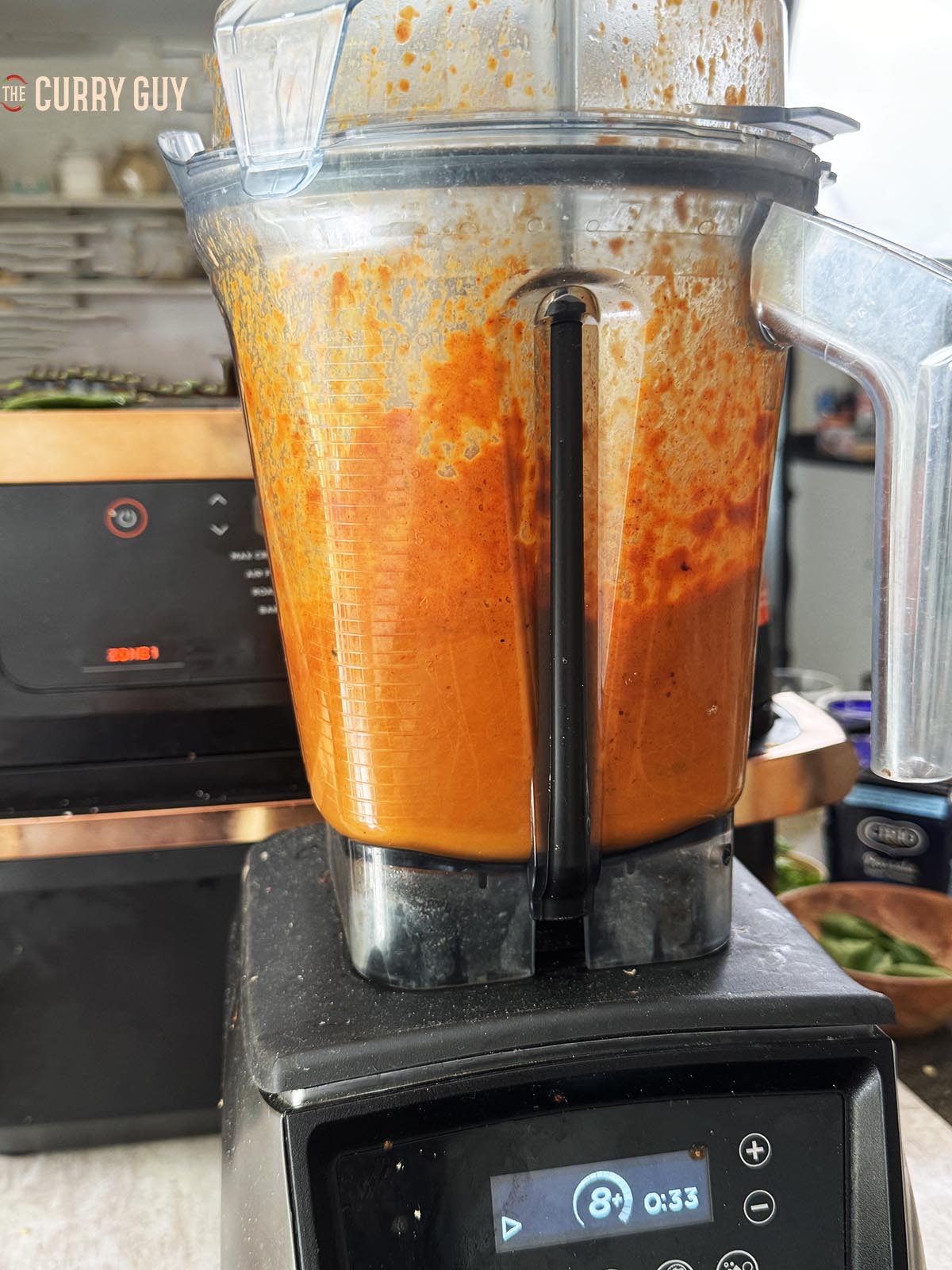 Blending the rezala sauce ingredients in a blender.
