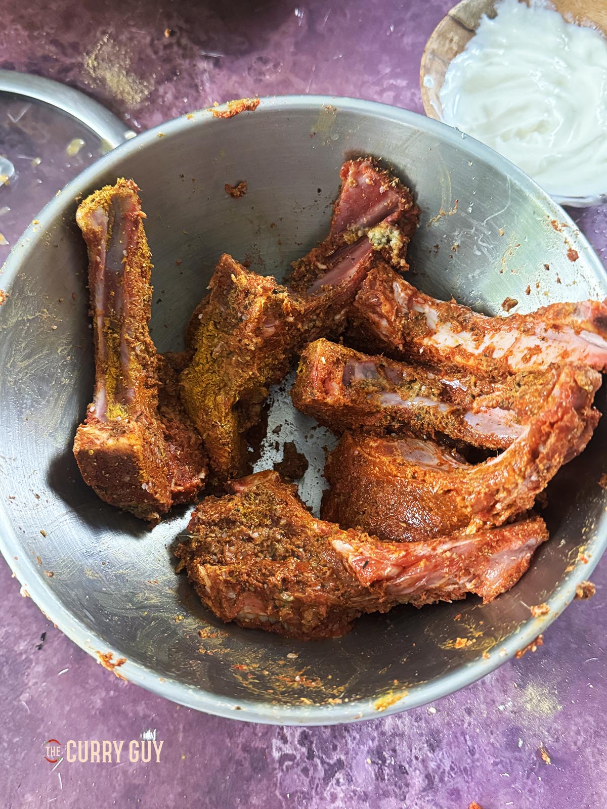 The lamb chops coated with spices. 