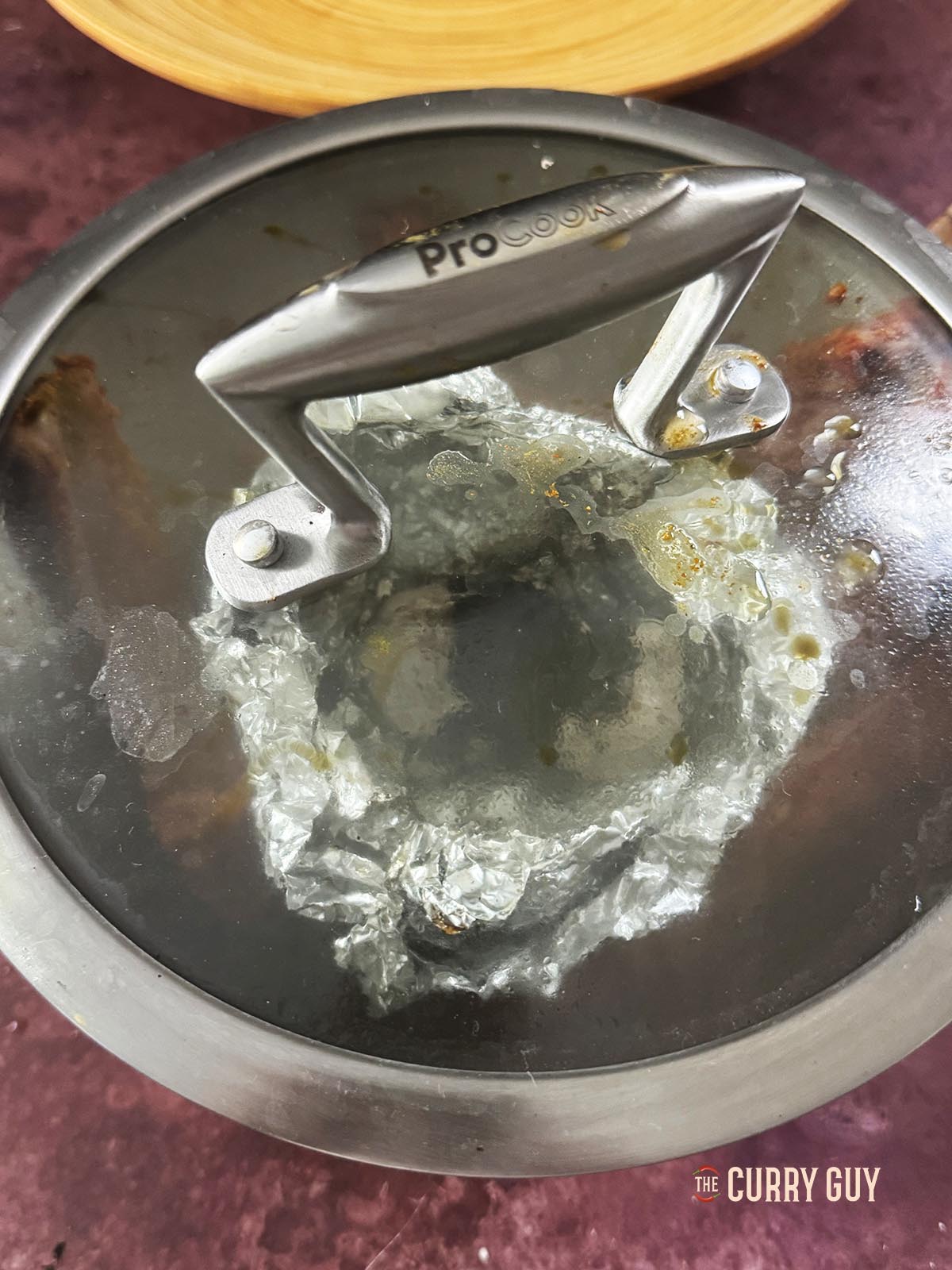 Looking at the lamb chops through a glass lid with the smoke gone.